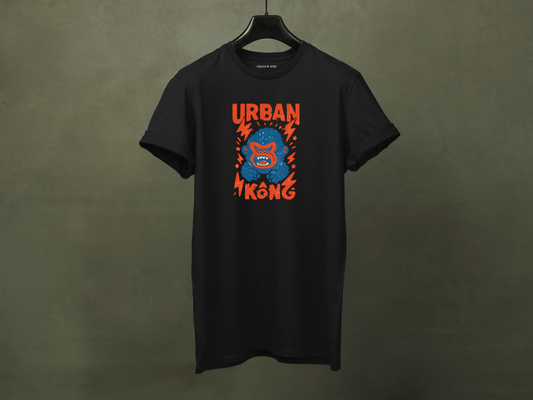 Hanged black streetwear t-shirt with a graphic of vibrant blue cartoon gorilla head, surrounded by red lightning bolts and stars, and the 'URBAN KONG' text in distressed red.