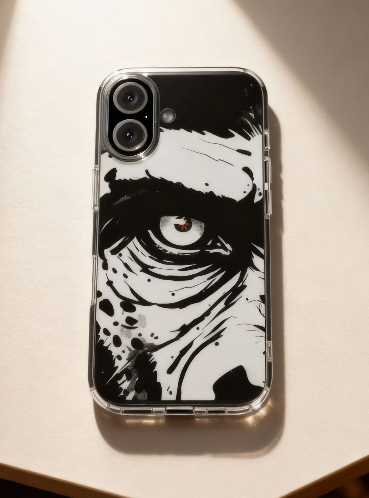 Phone case with black and white design on a light surface