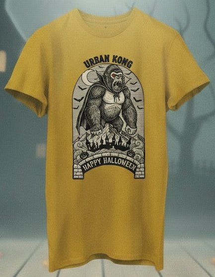 Yellow t-shirt with a gorilla graphic and 'Happy Halloween' text on a Halloween-themed background with pumpkins and a haunted house.