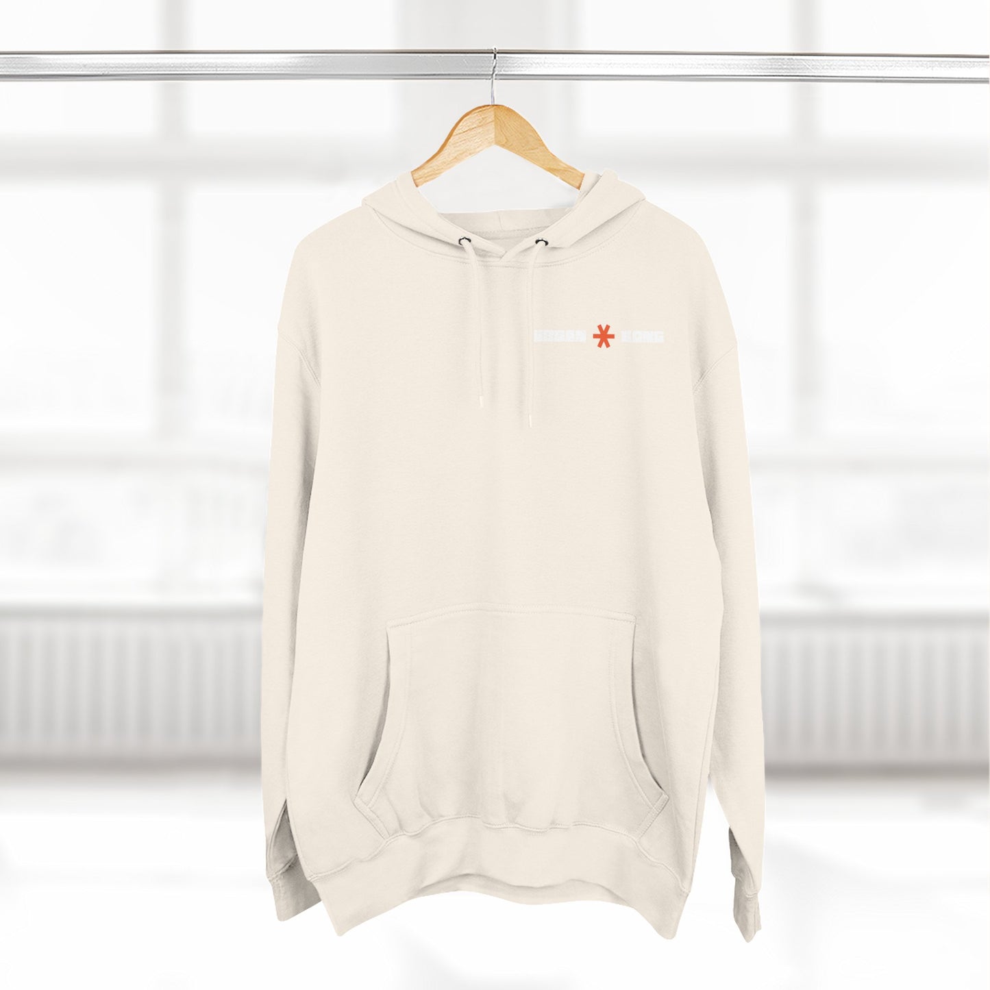 Beige hoodie with a red logo on a hanger against a white background