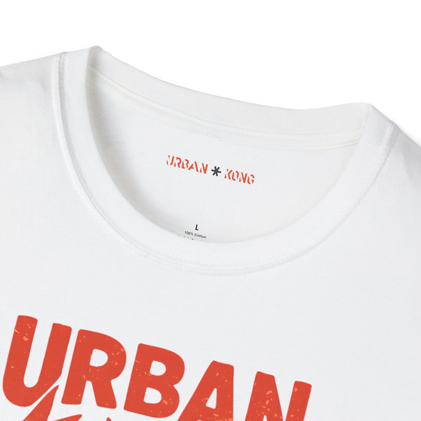 Label closeup of white streetwear t-shirt with a graphic of vibrant blue cartoon gorilla head, surrounded by red lightning bolts and stars, and the 'URBAN KONG' text in distressed red.