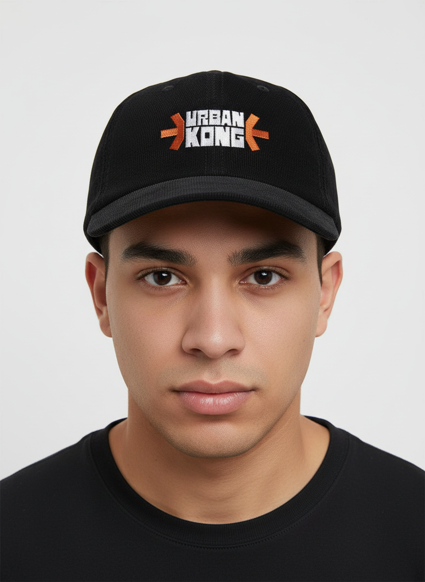 Person wearing a black cap with 'Urban Kong' logo on a light gray background