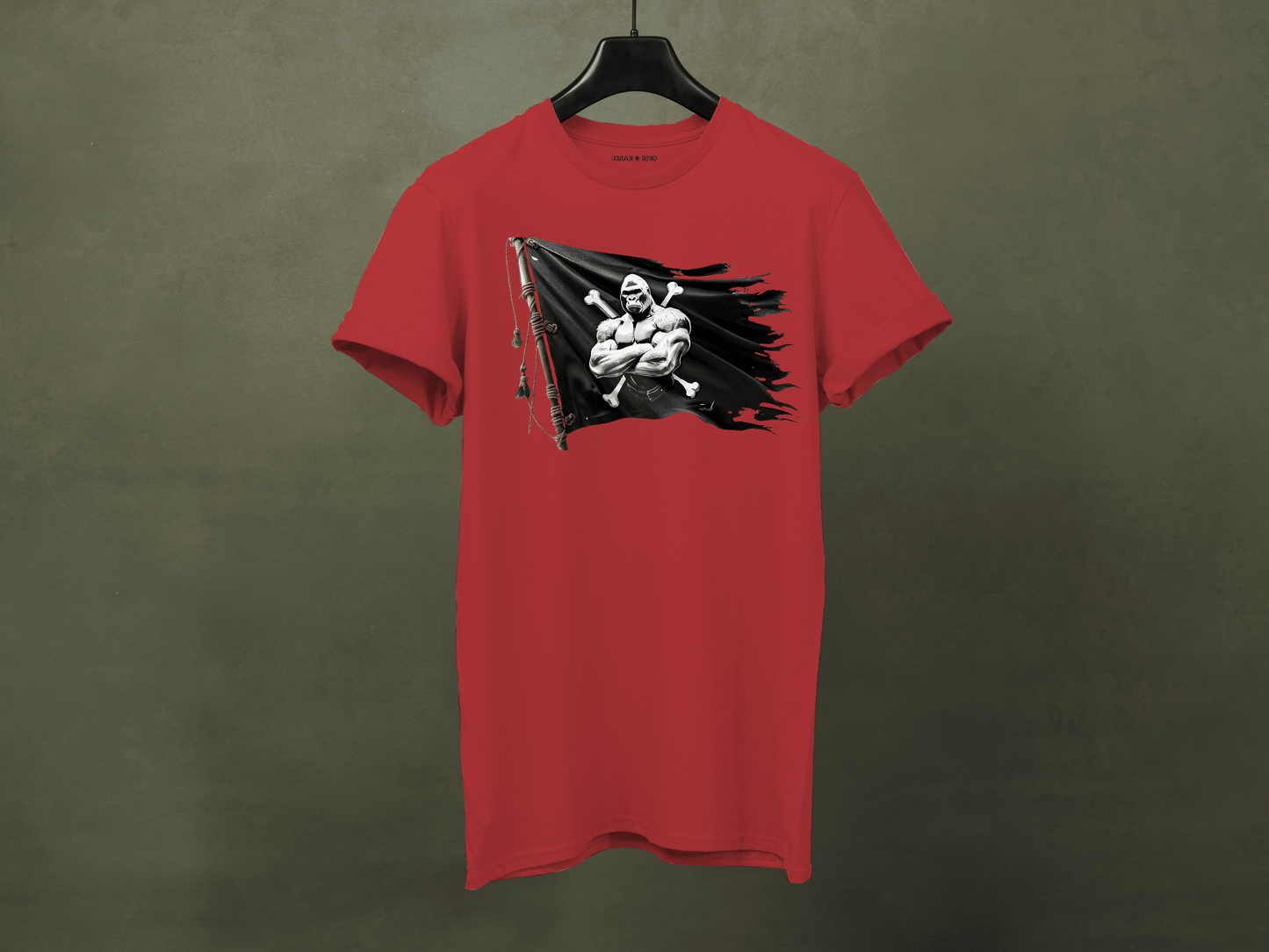 Red t-shirt with a graphic design on a hanger against a green background