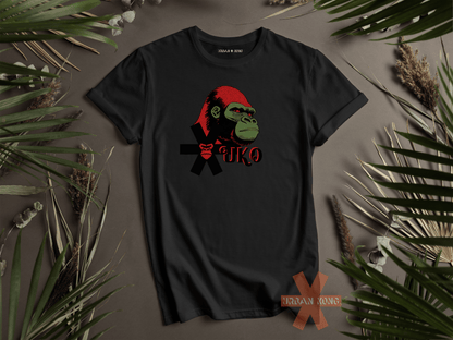 Black t-shirt with a graphic design of a monkey wearing a Santa hat on a brown background with green leaves.