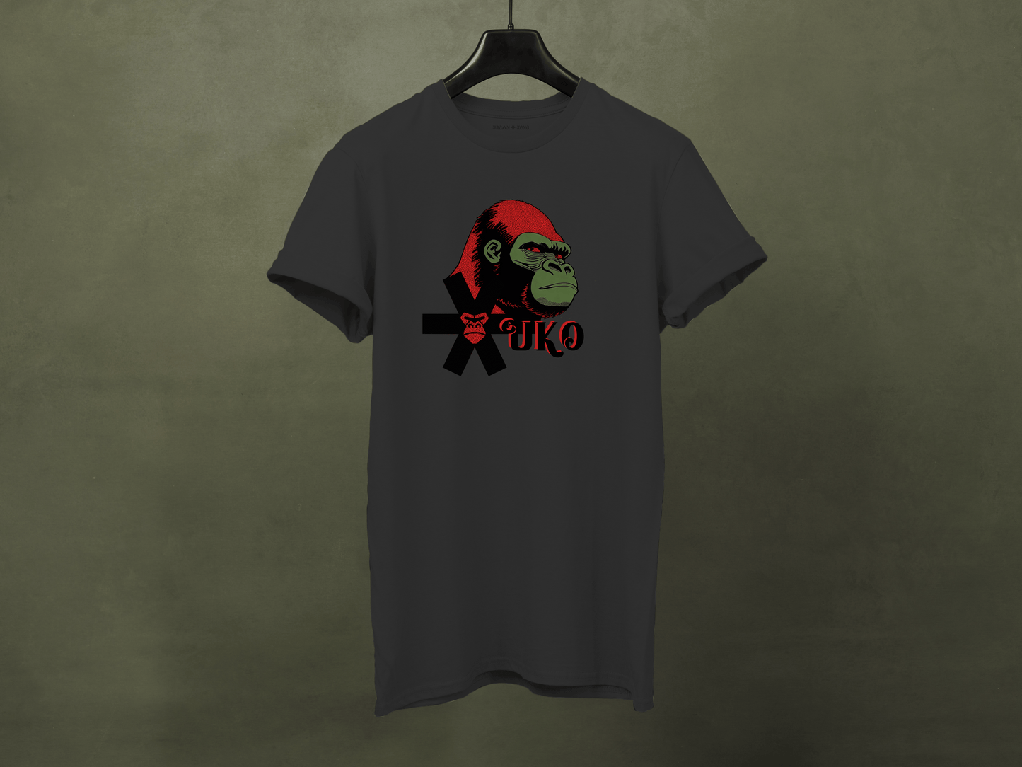 Gray t-shirt with a graphic of a monkey wearing a red hat and black jacket on a dark green background