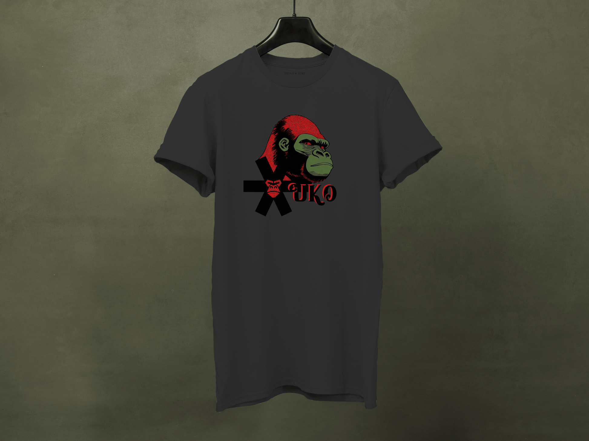 Gray t-shirt with a graphic of a monkey wearing a red hat and black jacket on a dark green background