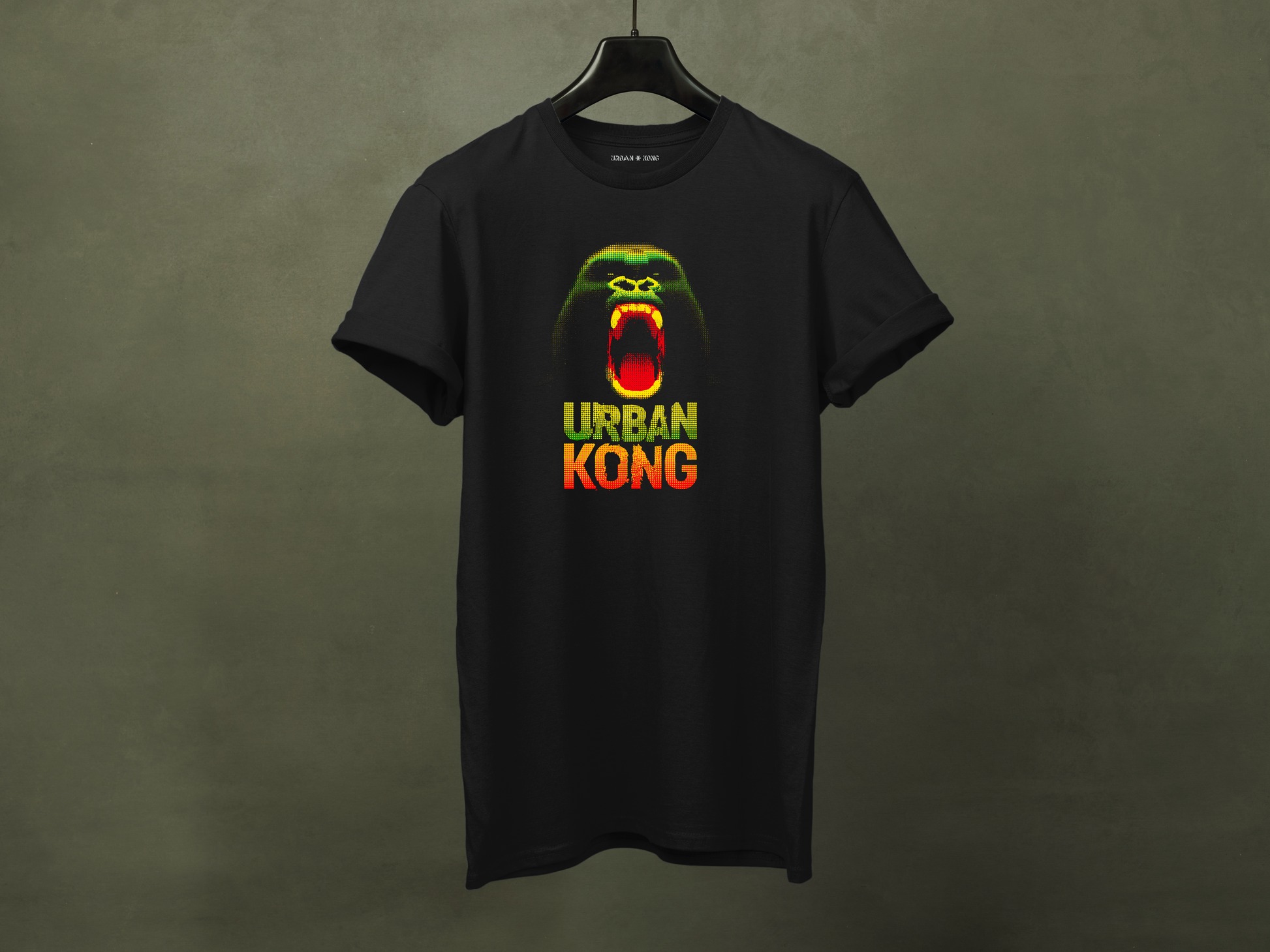 Black t-shirt on hanger featuring a pixelated art gorilla graphic in green, yellow, and red, with the text 'URBAN KONG' below in matching colors.