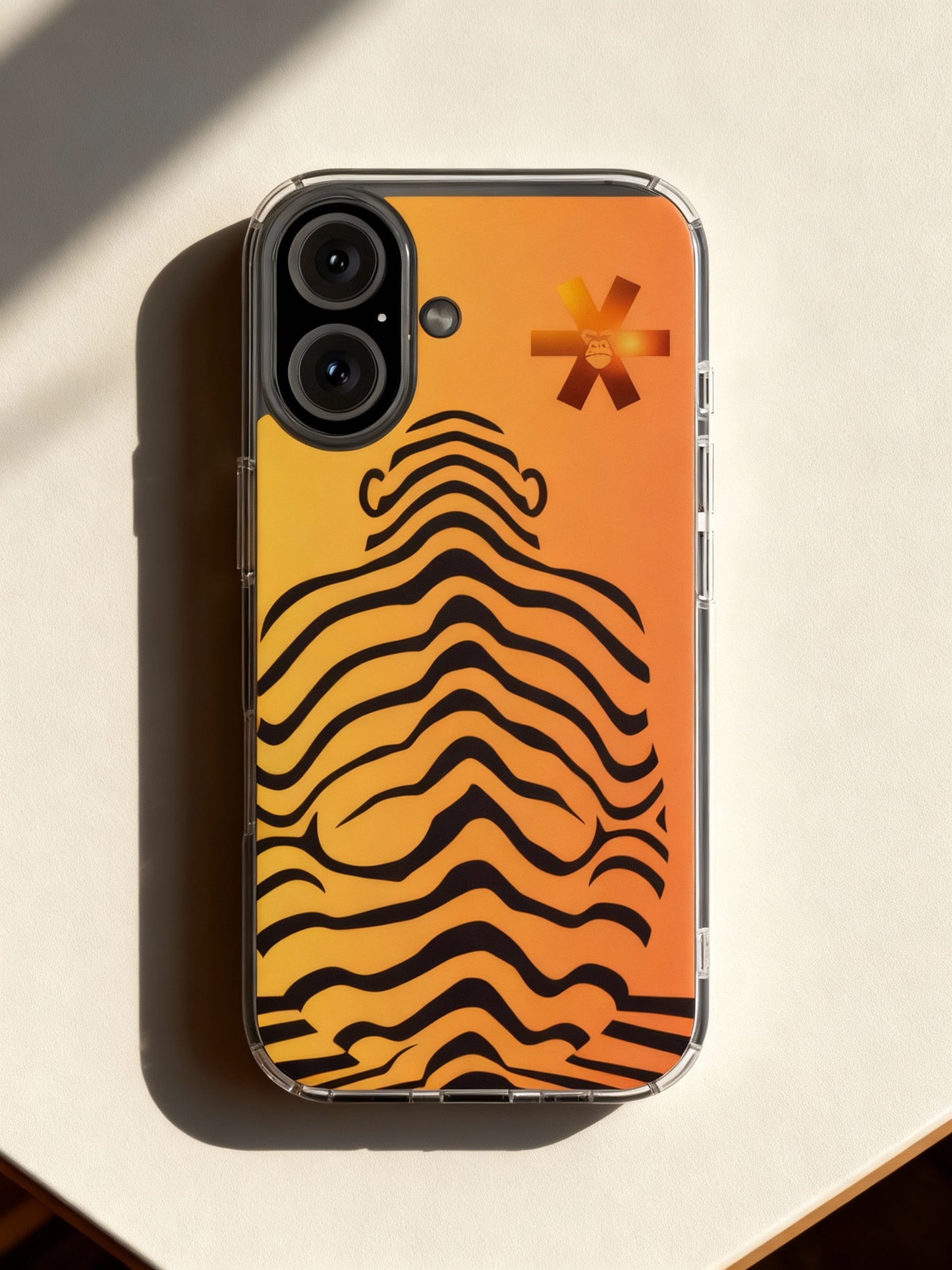 Phone case with tiger stripe pattern and brand logo on an orange background