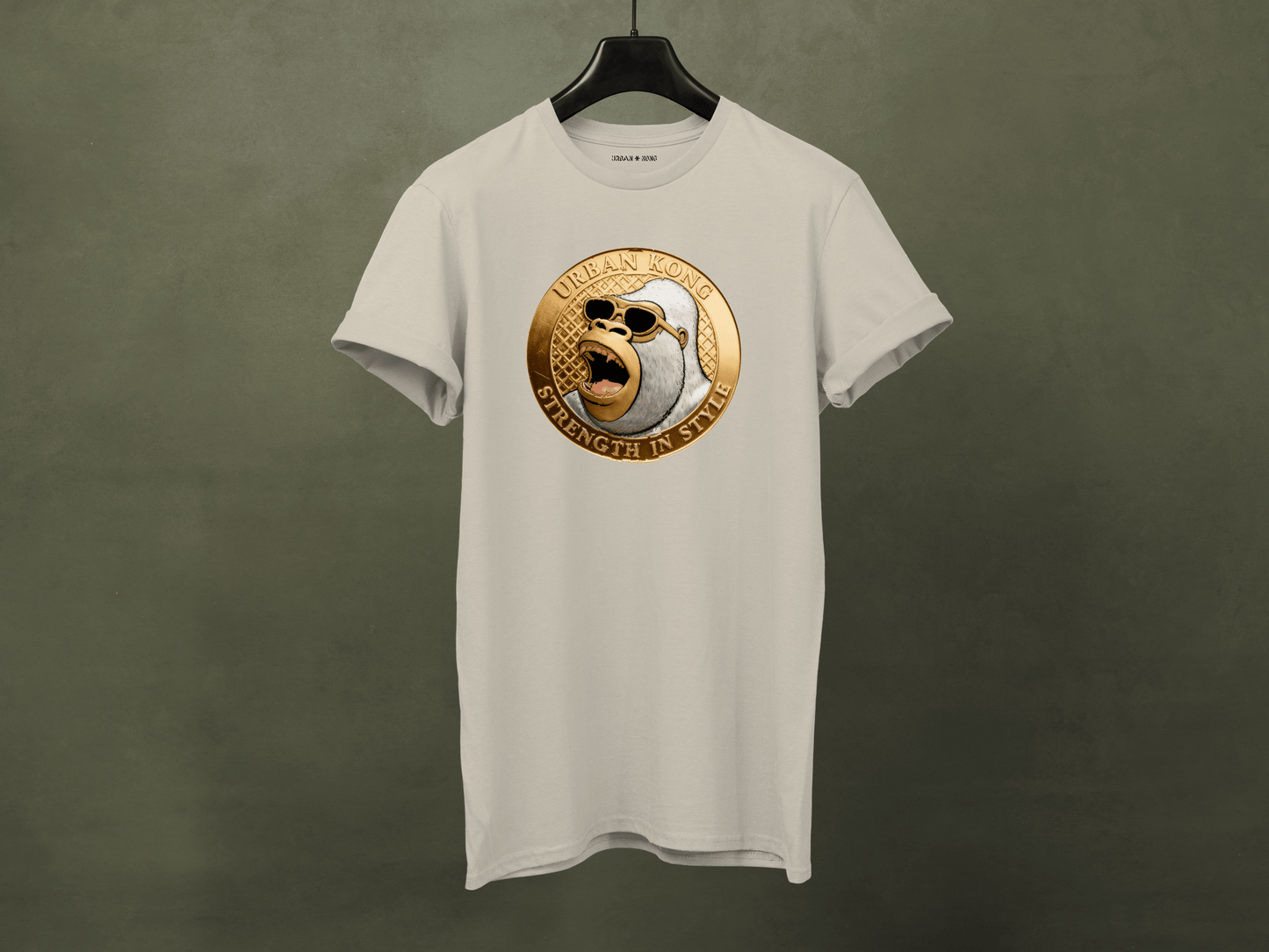 White t-shirt with a gold and black emblem on a dark green background