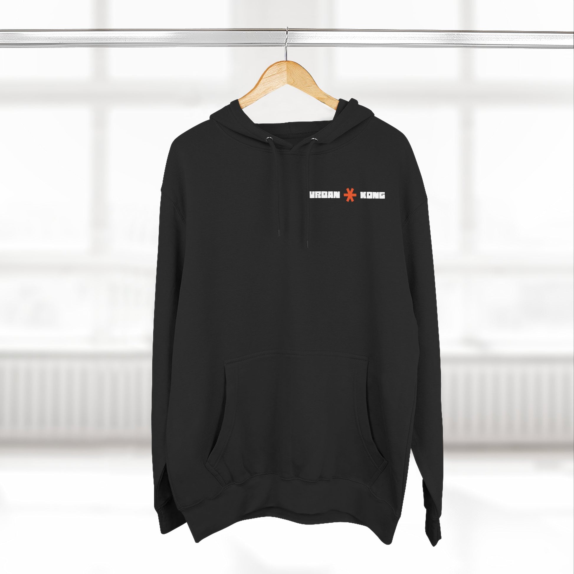 Black hoodie with a logo on a hanger against a white background