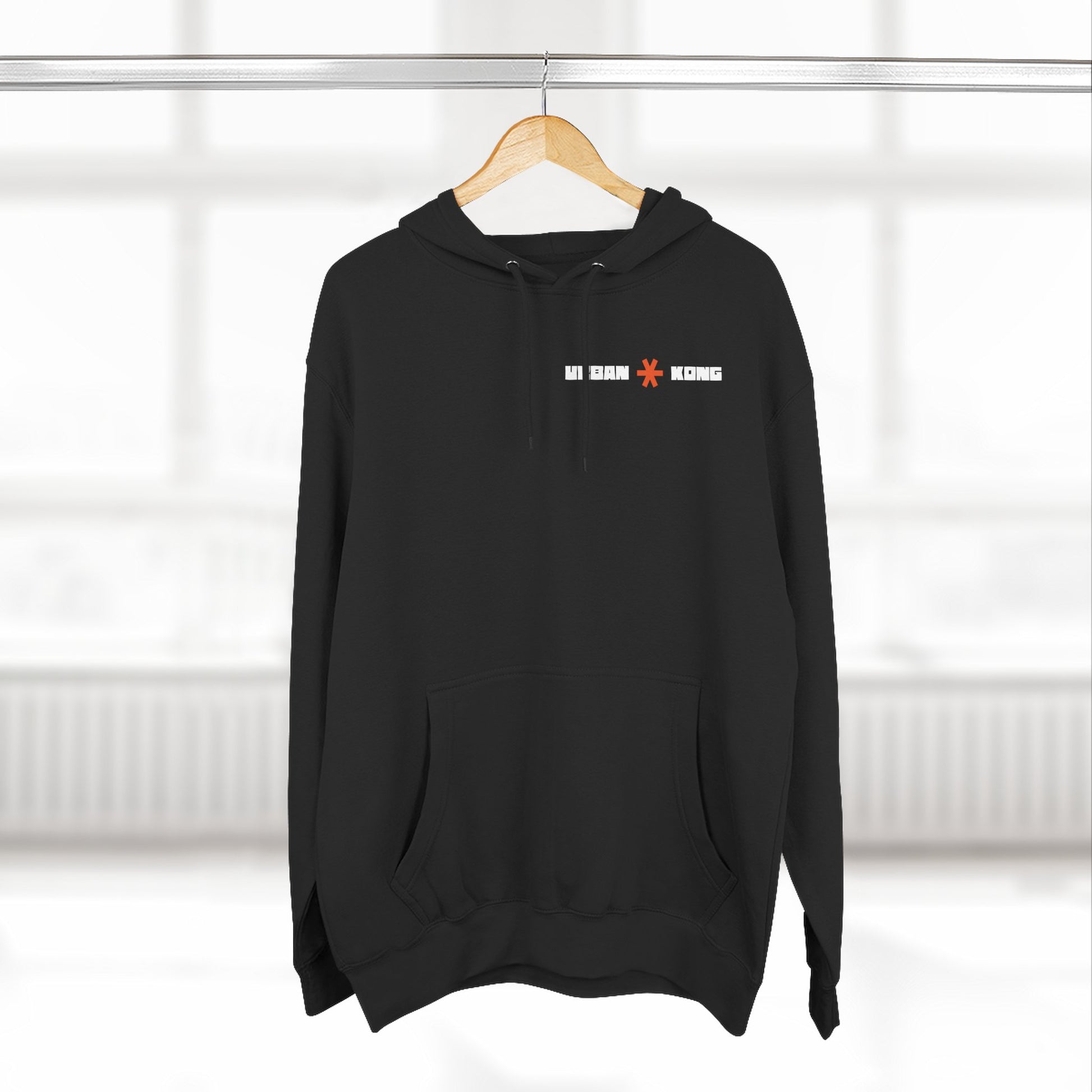 Black hoodie with text on a hanger against a white background