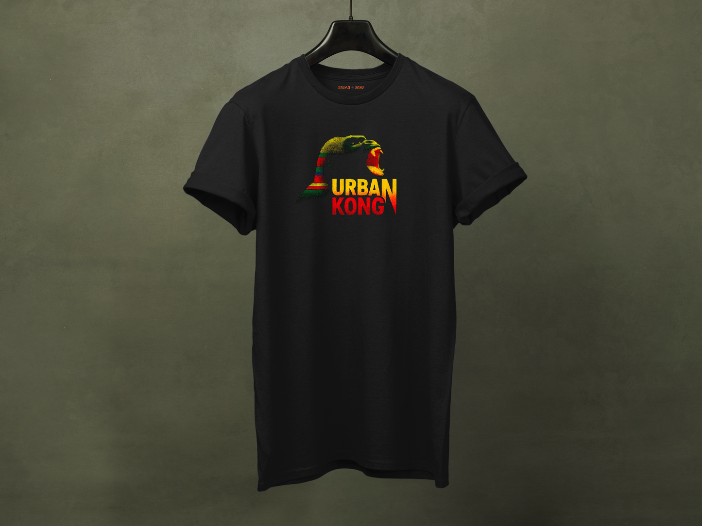 Hanged black streetwear t-shirt featuring a graphic of gorilla screaming in green, yellow, and red, with the text 'URBAN KONG' below in matching colors.