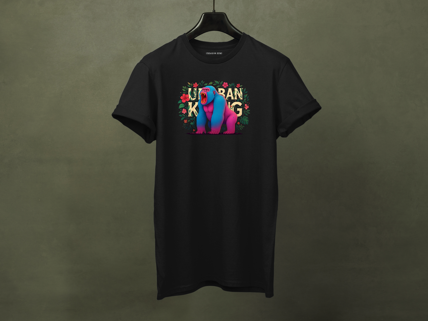 Hanged black streetwear t-shirt featuring a colourful neon graphic of a gorilla with pink and blue fur, sitting and roaring, surrounded by floral elements. The 'URBAN KONG' text is integrated into the floral border.