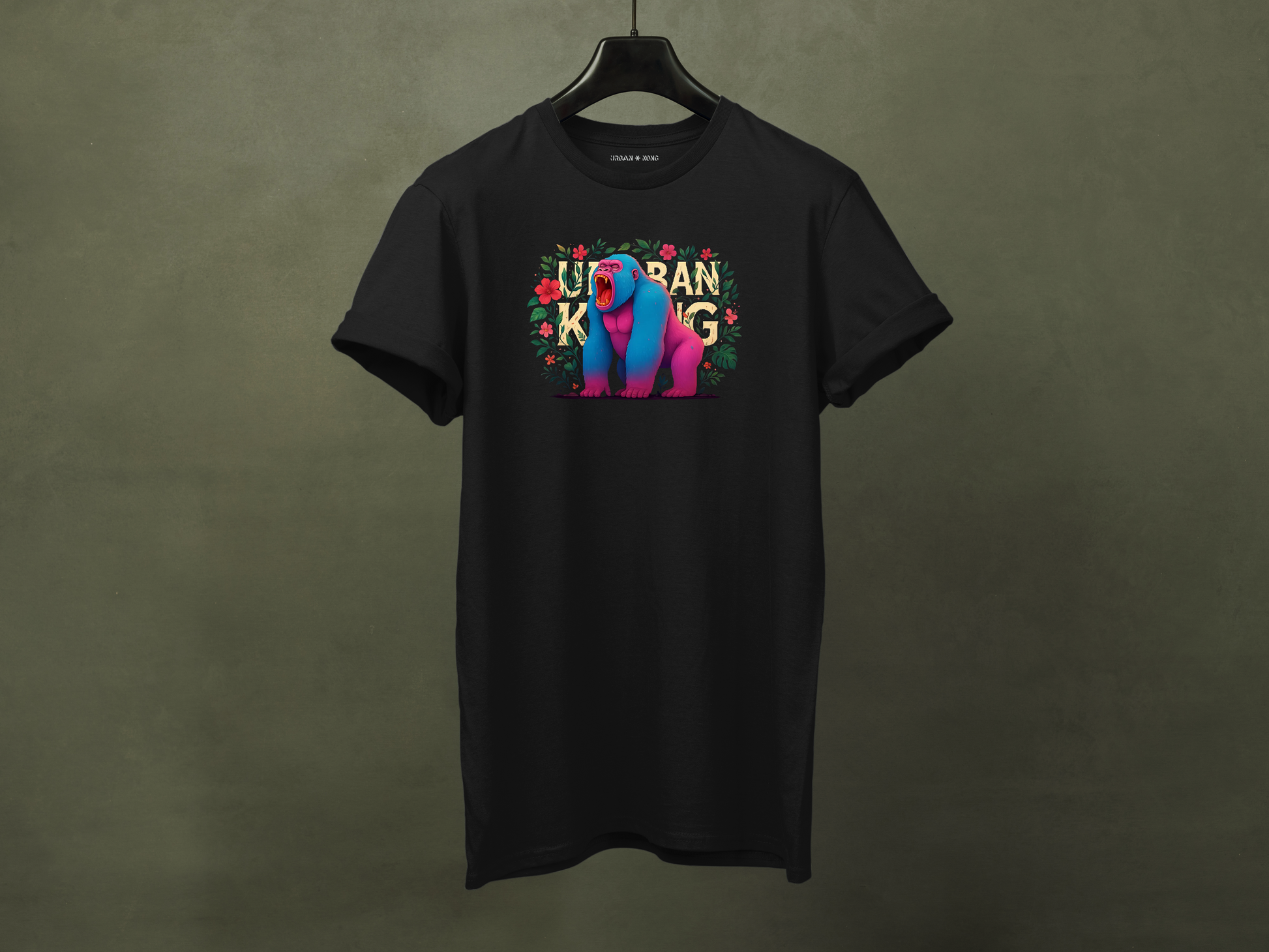 Hanged black streetwear t-shirt featuring a colourful neon graphic of a gorilla with pink and blue fur, sitting and roaring, surrounded by floral elements. The 'URBAN KONG' text is integrated into the floral border.