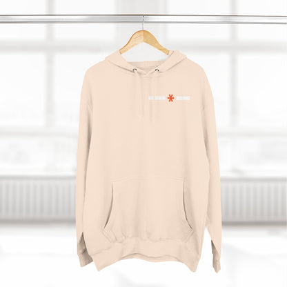 Beige hoodie with a logo on a hanger against a white background