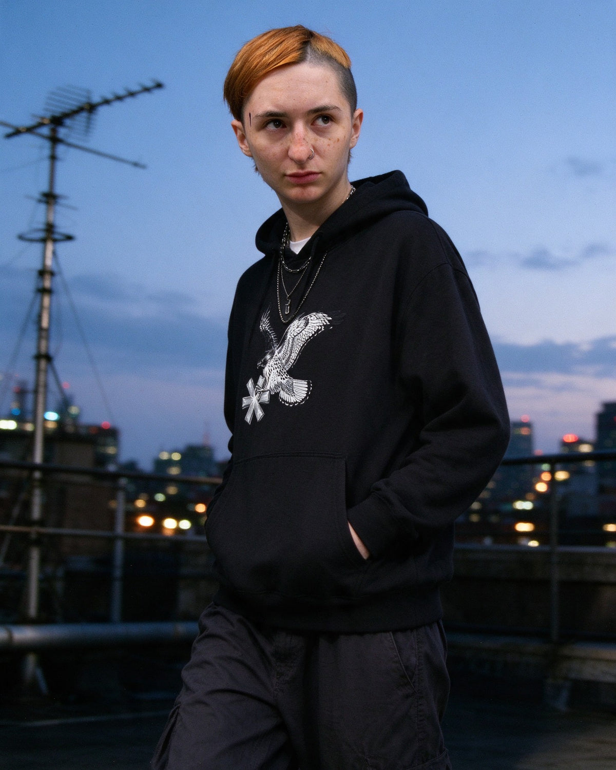 Falcon Strike Hoodie worn on the street — Urban Kong