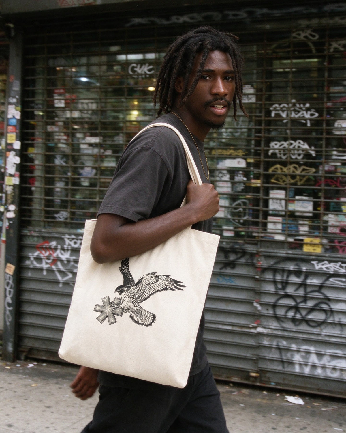 Falcon Strike Tote Bag worn on the street — Urban Kong
